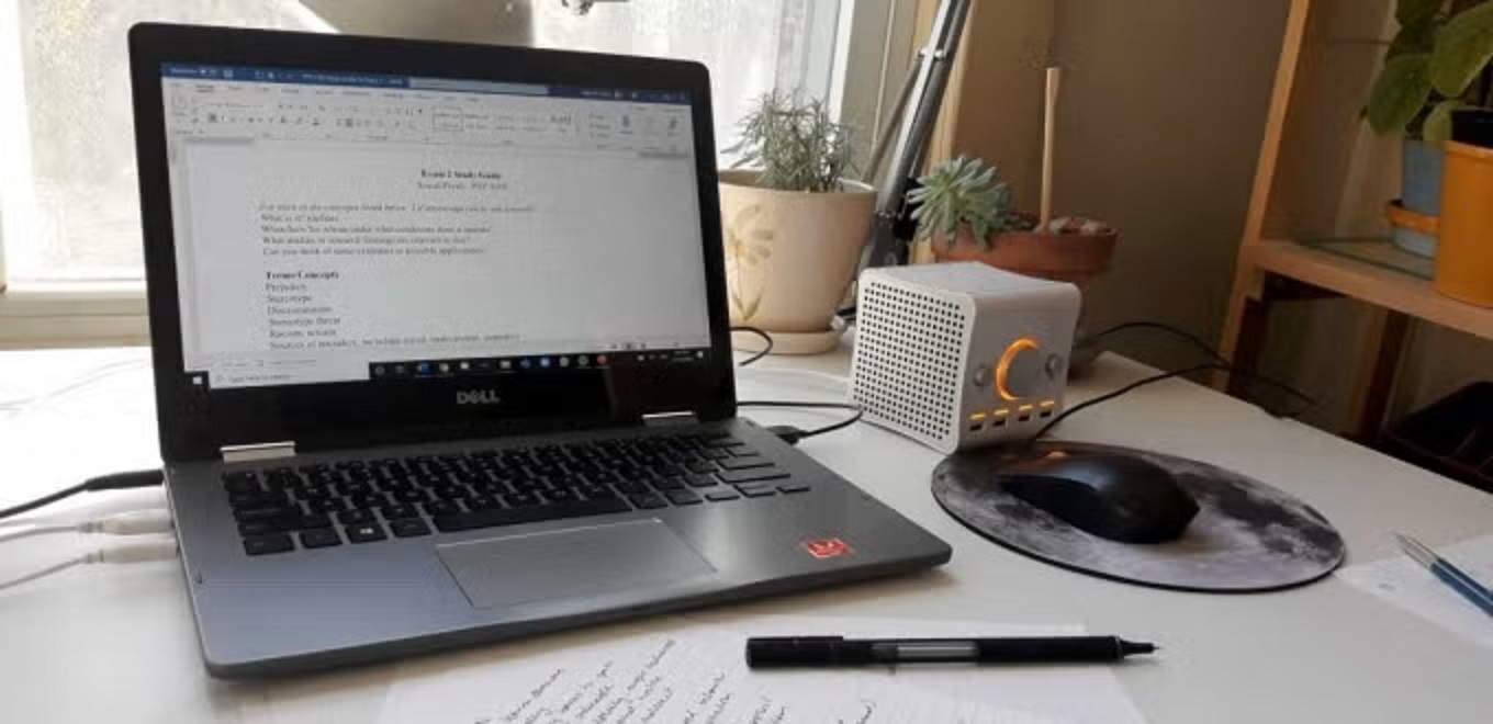 laptop of desk with final paper on screen