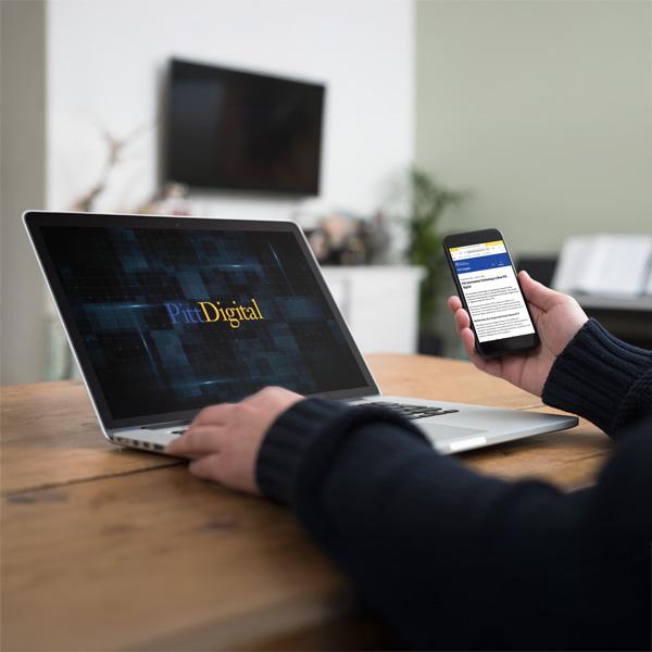 laptop and phone displaying Pitt Digital logos