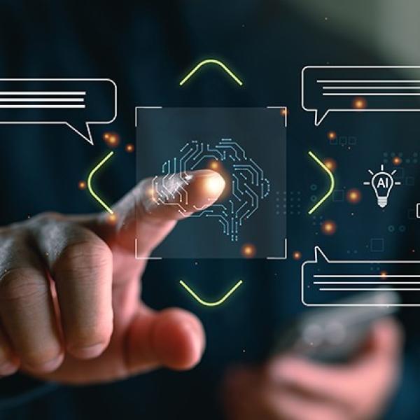 Finger pointing to digital depiction of a brain surrounded by chat bubbles