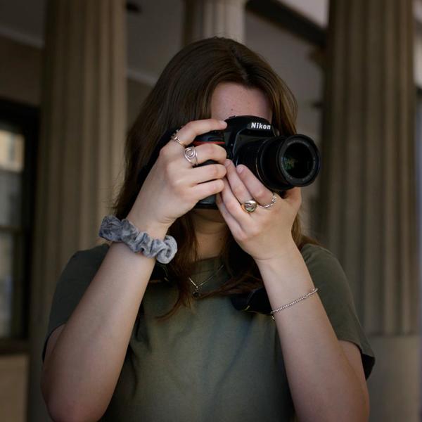 Student holding camera to her eye