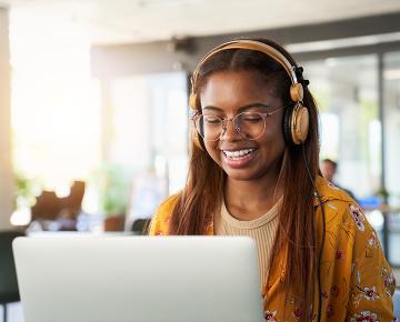 Happy college student using computer